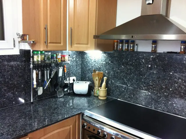 Kitchen with gas stove and hood